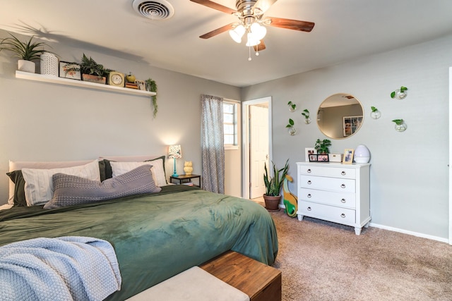 bedroom with a ceiling fan, visible vents, carpet floors, and baseboards