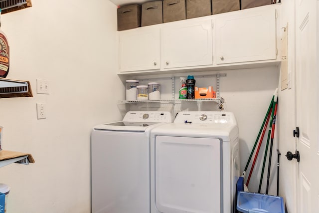 laundry area with washing machine and dryer and cabinet space