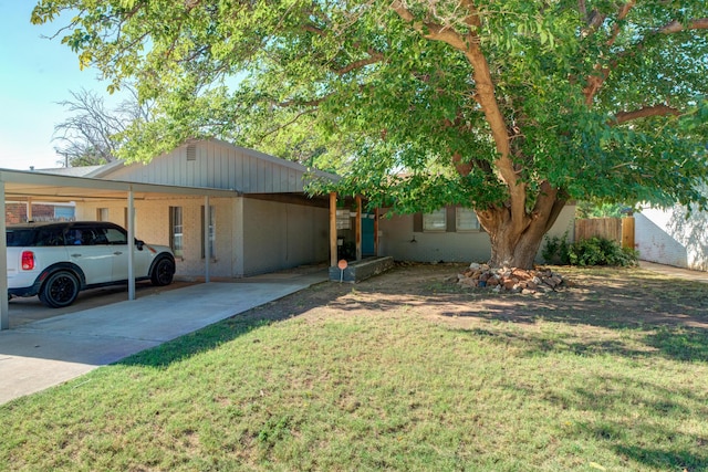 ranch-style home featuring fence, a carport, concrete driveway, and a front lawn