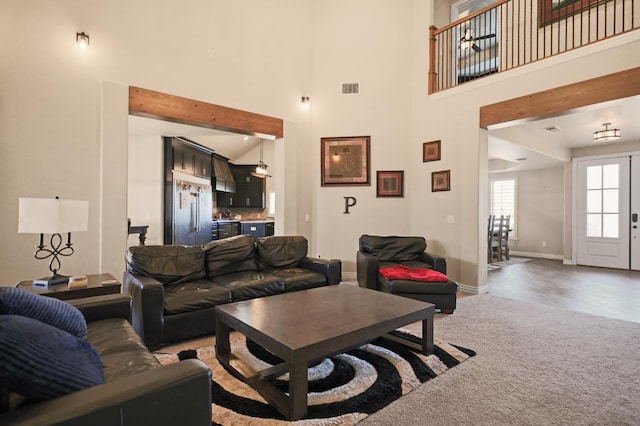 living room with carpet flooring and a high ceiling