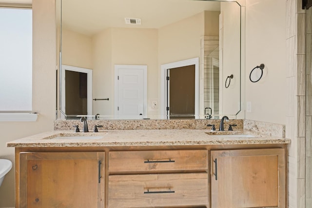 bathroom with vanity and an enclosed shower