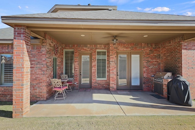 view of patio with ceiling fan, a grill, and exterior kitchen