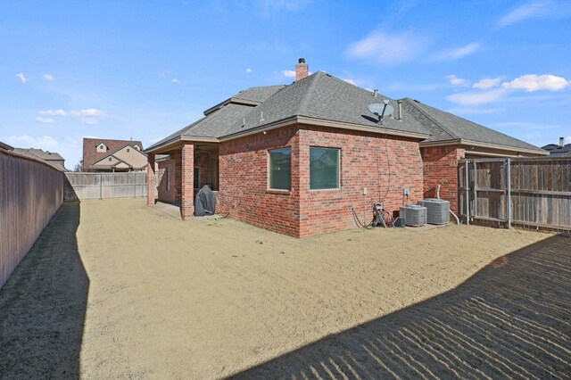 rear view of property featuring cooling unit and a patio