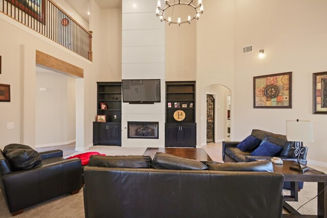 living room with a chandelier and a high ceiling