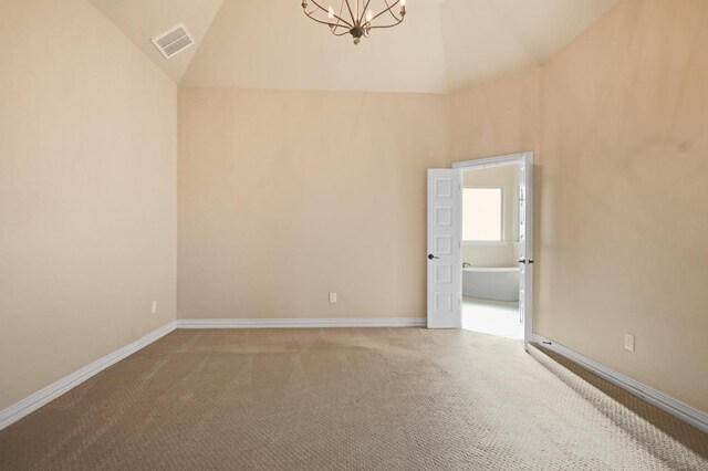 unfurnished room featuring a notable chandelier, high vaulted ceiling, and carpet