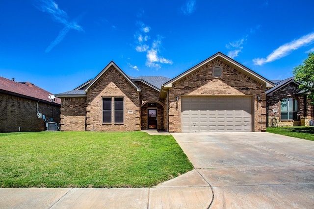 ranch-style home with a garage, driveway, a front yard, central AC, and brick siding