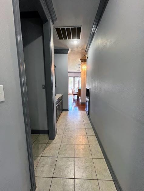 hall featuring light tile patterned flooring