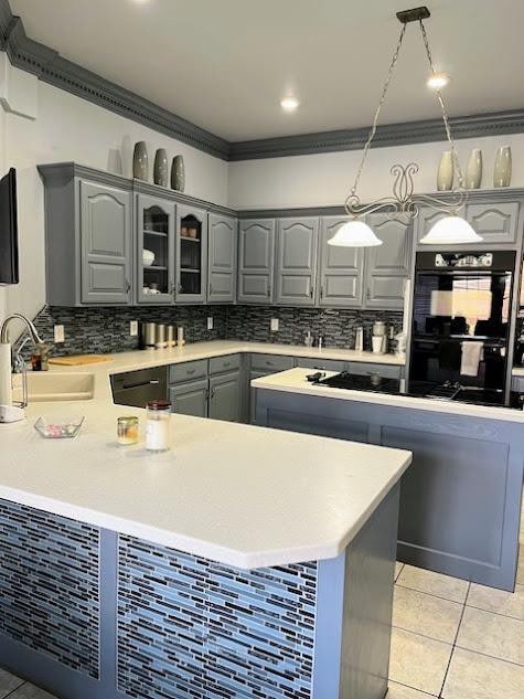 kitchen with crown molding, sink, hanging light fixtures, and light tile patterned floors