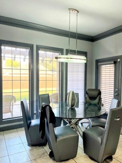 dining space with crown molding, plenty of natural light, and light tile patterned floors