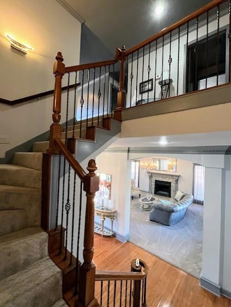 staircase with a high ceiling and wood-type flooring