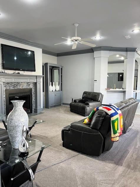 living room with ornate columns, crown molding, carpet floors, and ceiling fan