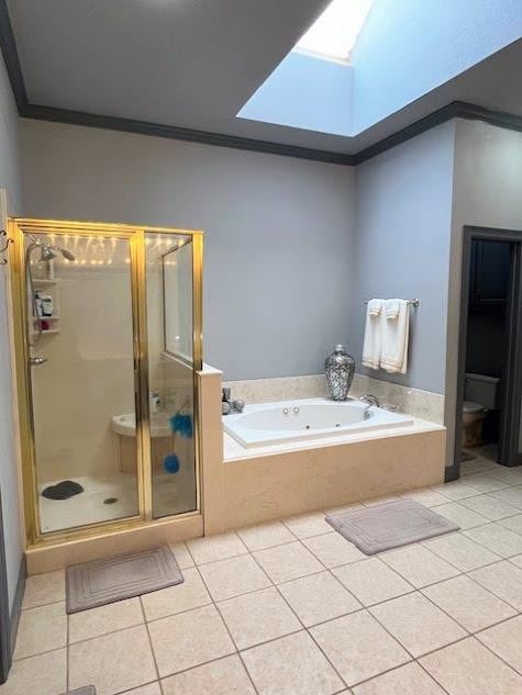 bathroom featuring tile patterned flooring, ornamental molding, separate shower and tub, and a skylight