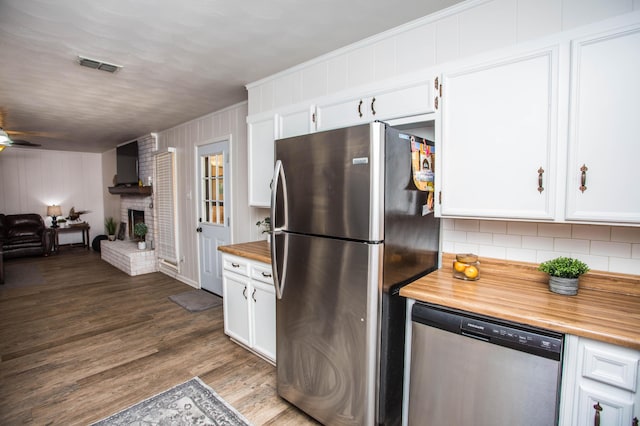 5303 46th St, Lubbock, TX 79414 - kitchen featuring open floor plan, wooden counters, visible vents, decorative backsplash, and appliances with stainless steel finishes