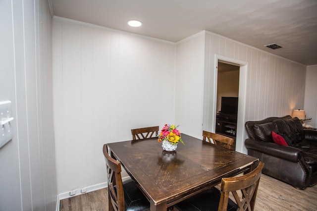 5303 46th St, Lubbock, TX 79414 - dining space with crown molding, visible vents, and wood finished floors