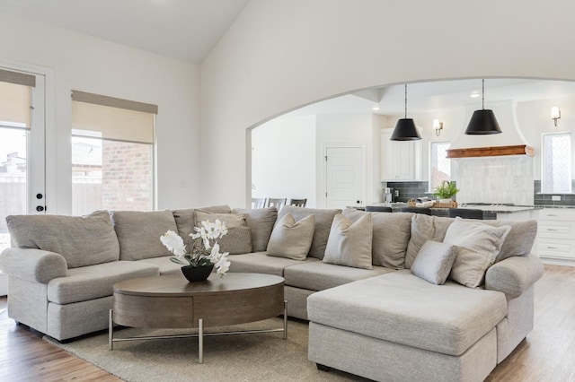 3621 121st St, Lubbock, TX 79423 - living room with arched walkways, light wood finished floors, high vaulted ceiling, and recessed lighting