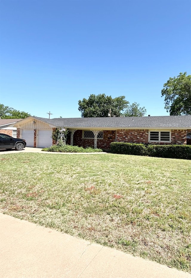 ranch-style home featuring a garage and a front yard