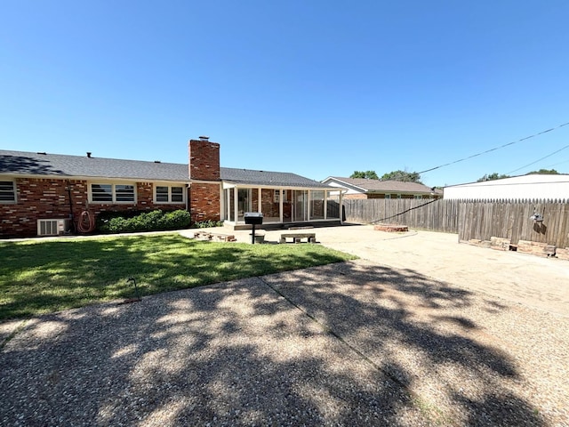 back of property featuring a yard and a patio