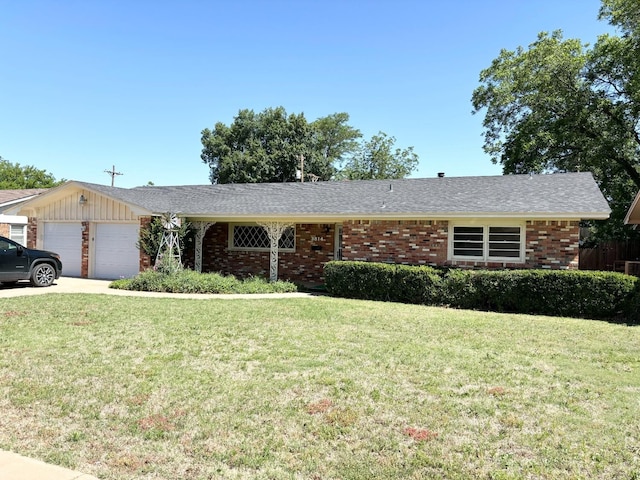 ranch-style home featuring a garage and a front lawn