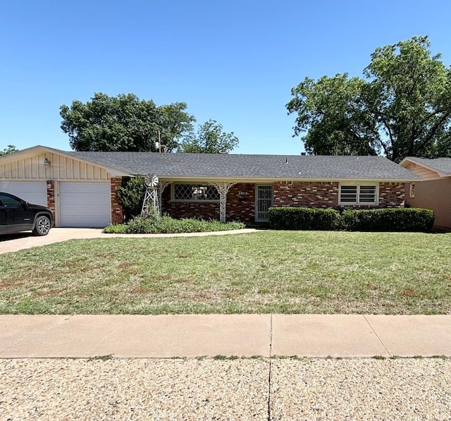 ranch-style home featuring a garage and a front lawn