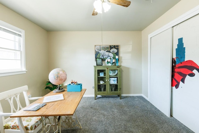 carpeted office featuring ceiling fan