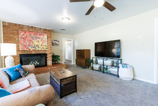 carpeted living room with ceiling fan and a brick fireplace