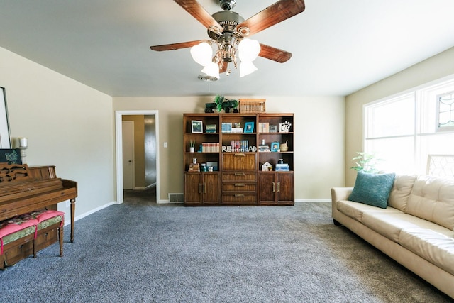 sitting room with ceiling fan and carpet flooring