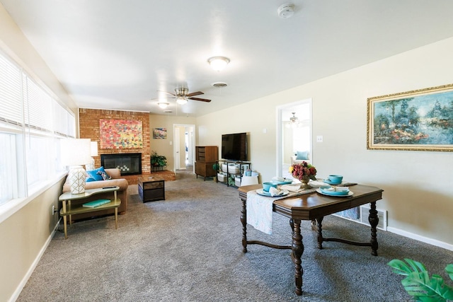 carpeted living room with a brick fireplace and ceiling fan