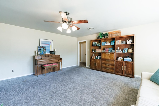 sitting room with ceiling fan and carpet floors