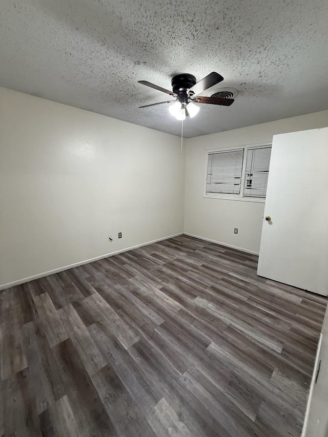 spare room with ceiling fan, dark hardwood / wood-style floors, and a textured ceiling