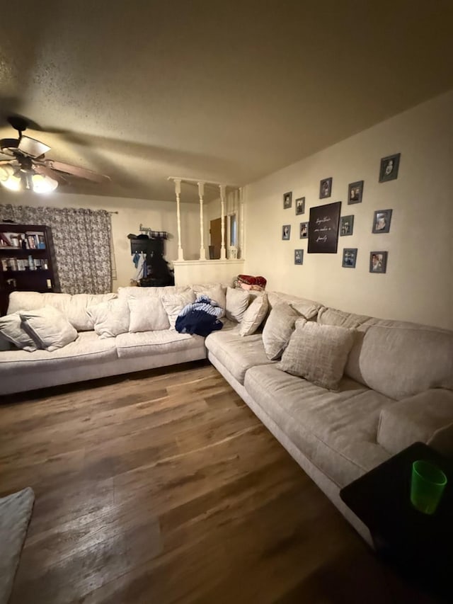 living room featuring vaulted ceiling, hardwood / wood-style floors, and ceiling fan