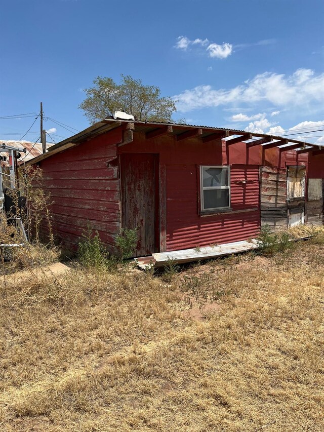 view of home's exterior with an outbuilding
