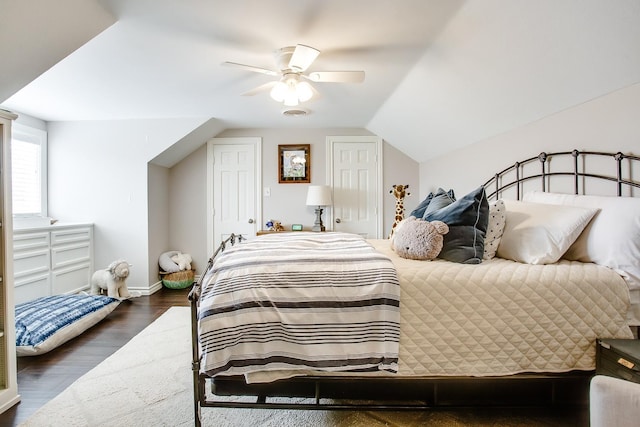 bedroom with lofted ceiling, dark wood-type flooring, and ceiling fan