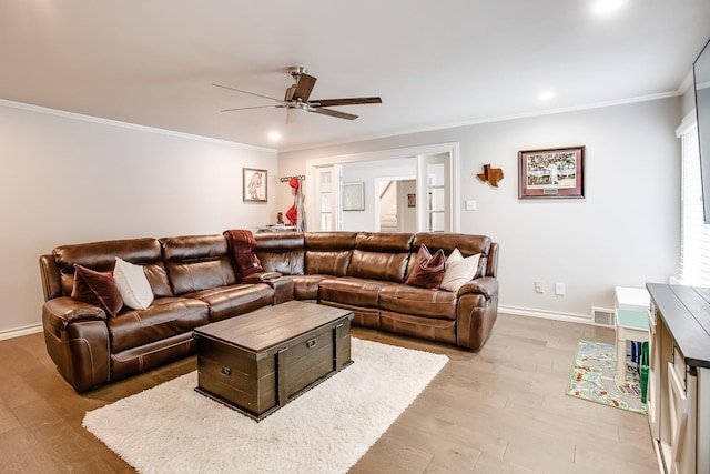 living room with crown molding, ceiling fan, and light hardwood / wood-style flooring