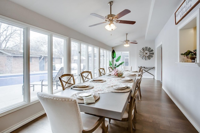 dining space featuring dark hardwood / wood-style flooring and vaulted ceiling