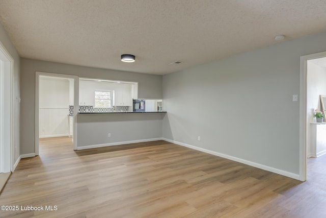 4013 48th St, Lubbock, TX 79413 - spare room with a textured ceiling, light wood-type flooring, and a smoke detector