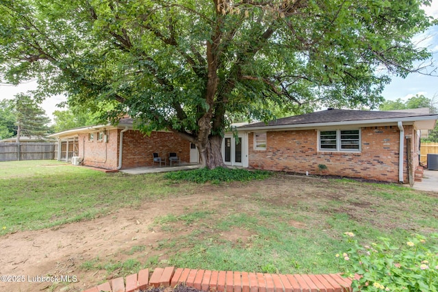 4013 48th St, Lubbock, TX 79413 - rear view of property featuring brick siding and a patio area