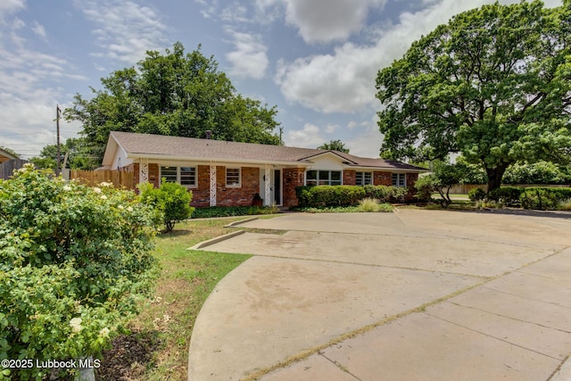 4013 48th St, Lubbock, TX 79413 - ranch-style home featuring brick siding and concrete driveway