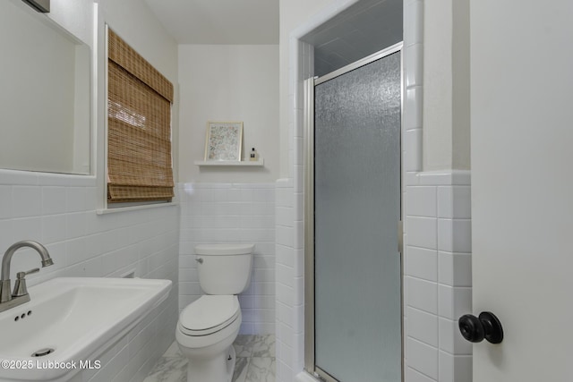 4013 48th St, Lubbock, TX 79413 - bathroom with tile walls, a shower stall, marble finish floors, and a wainscoted wall