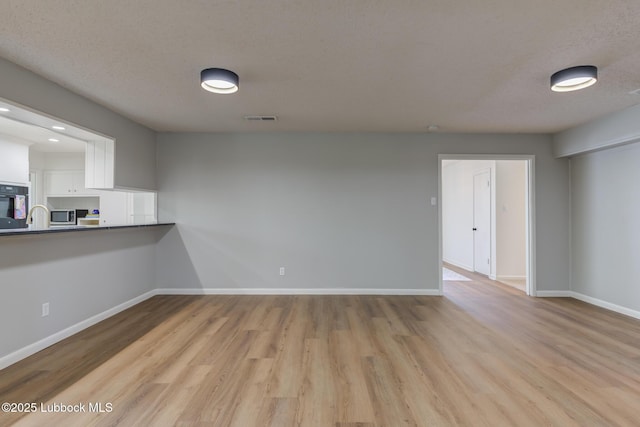 4013 48th St, Lubbock, TX 79413 - spare room featuring wood finished floors and baseboards
