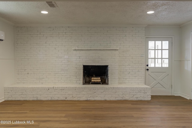 4013 48th St, Lubbock, TX 79413 - unfurnished living room with a textured ceiling, wood finished floors, ornamental molding, a fireplace, and recessed lighting