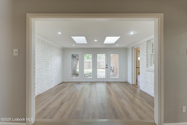 4013 48th St, Lubbock, TX 79413 - empty room with brick wall, a skylight, wood finished floors, and ornamental molding