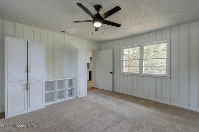 4013 48th St, Lubbock, TX 79413 - unfurnished bedroom with a textured ceiling, light colored carpet, and a ceiling fan