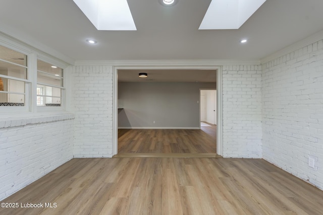 4013 48th St, Lubbock, TX 79413 - unfurnished room featuring brick wall, a skylight, light wood-type flooring, recessed lighting, and crown molding