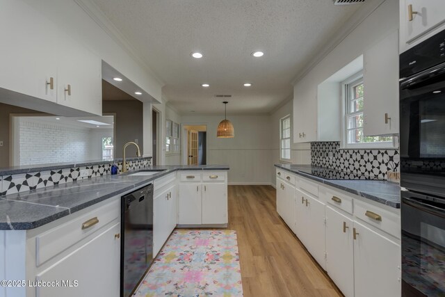 4013 48th St, Lubbock, TX 79413 - kitchen featuring black appliances, recessed lighting, backsplash, white cabinets, and light wood-type flooring