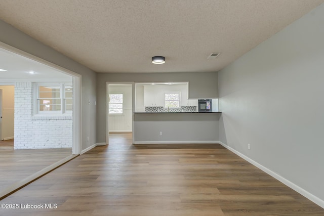 4013 48th St, Lubbock, TX 79413 - unfurnished room featuring a textured ceiling and wood finished floors