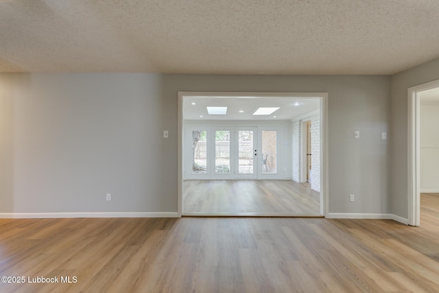 4013 48th St, Lubbock, TX 79413 - unfurnished room featuring light wood-style floors and a textured ceiling