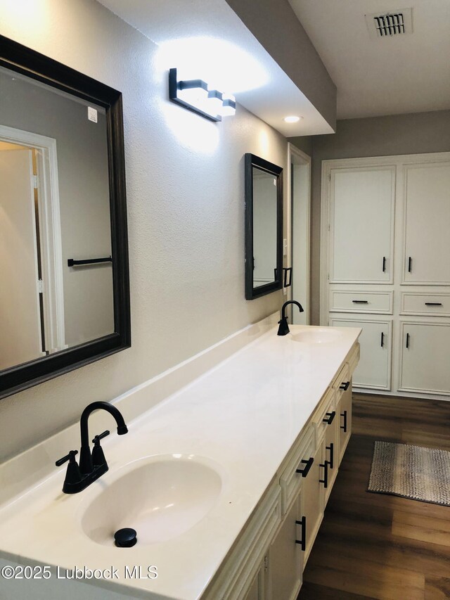 5712 73rd St, Lubbock, TX 79424 - bathroom with double vanity and wood finished floors