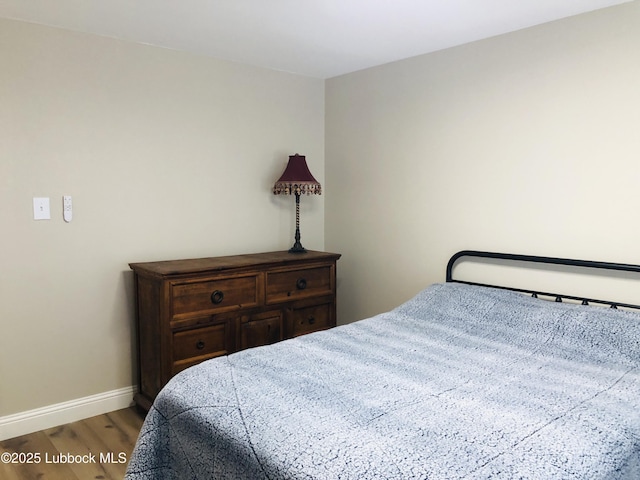 5712 73rd St, Lubbock, TX 79424 - bedroom featuring wood finished floors and baseboards