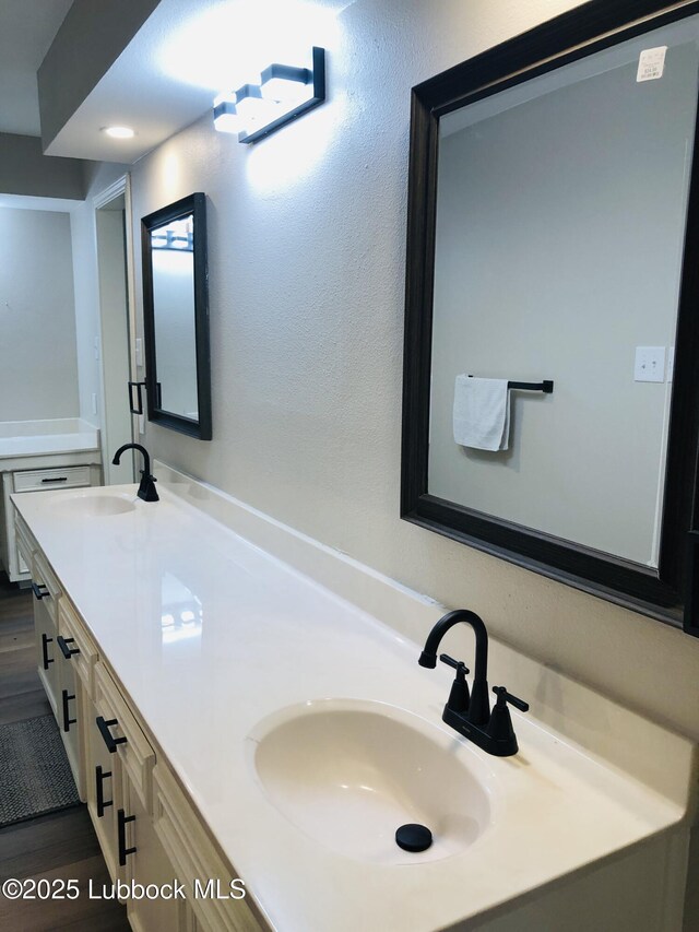 5712 73rd St, Lubbock, TX 79424 - full bathroom with double vanity and wood finished floors