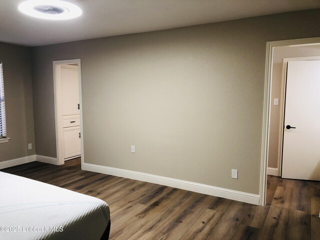 5712 73rd St, Lubbock, TX 79424 - bedroom featuring dark wood-style floors and baseboards